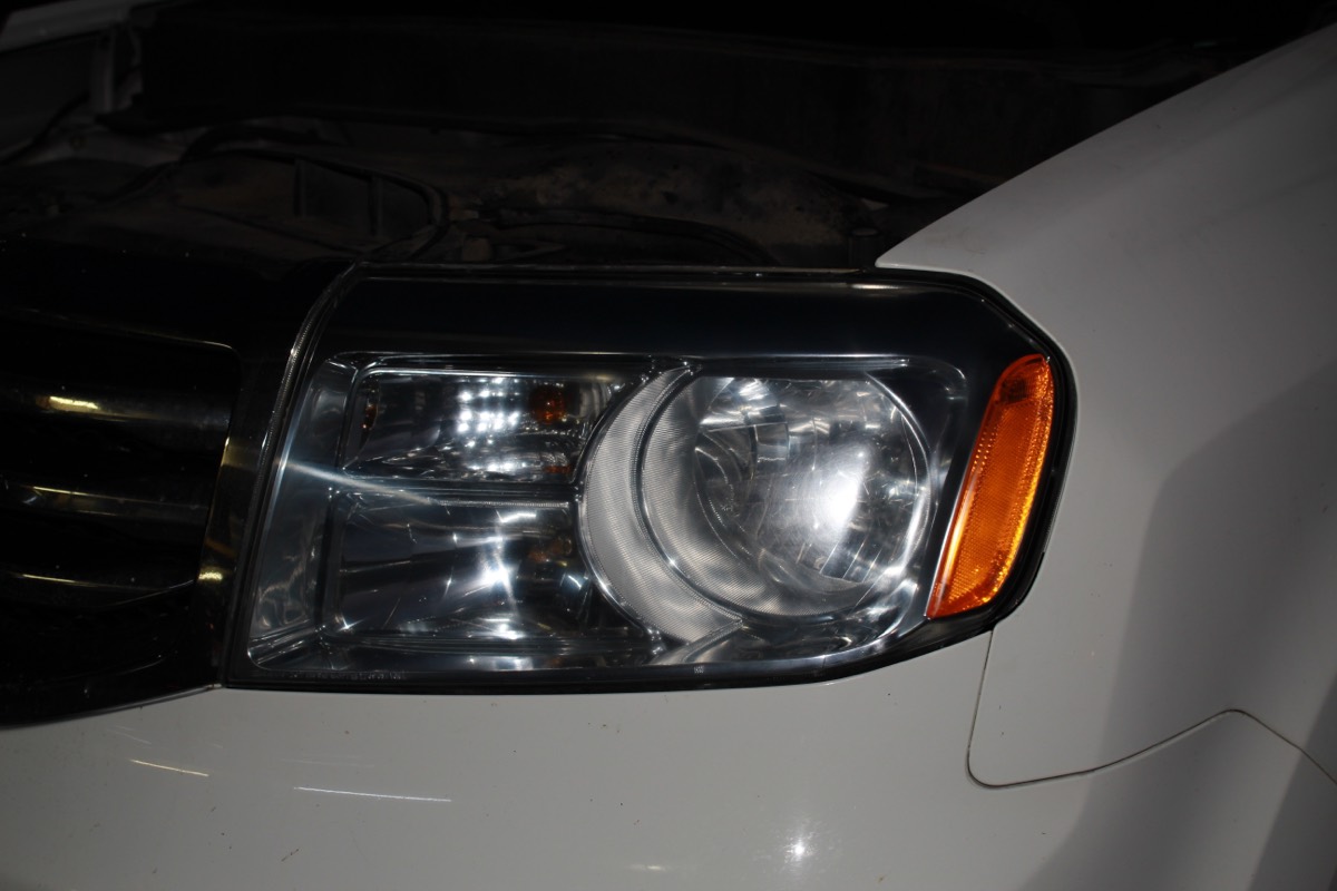 The same Honda Pilot driver side headlight after restoration, crisp and transparent
